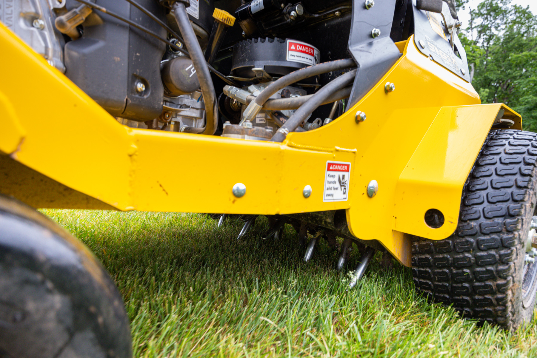 close up of an aerator pulling soil plugs